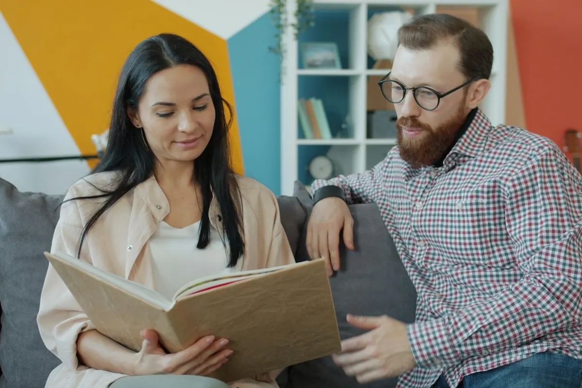 Couple looking at an open photo album together