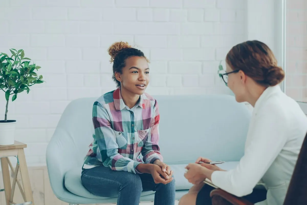 Two women talking in a modern office setting