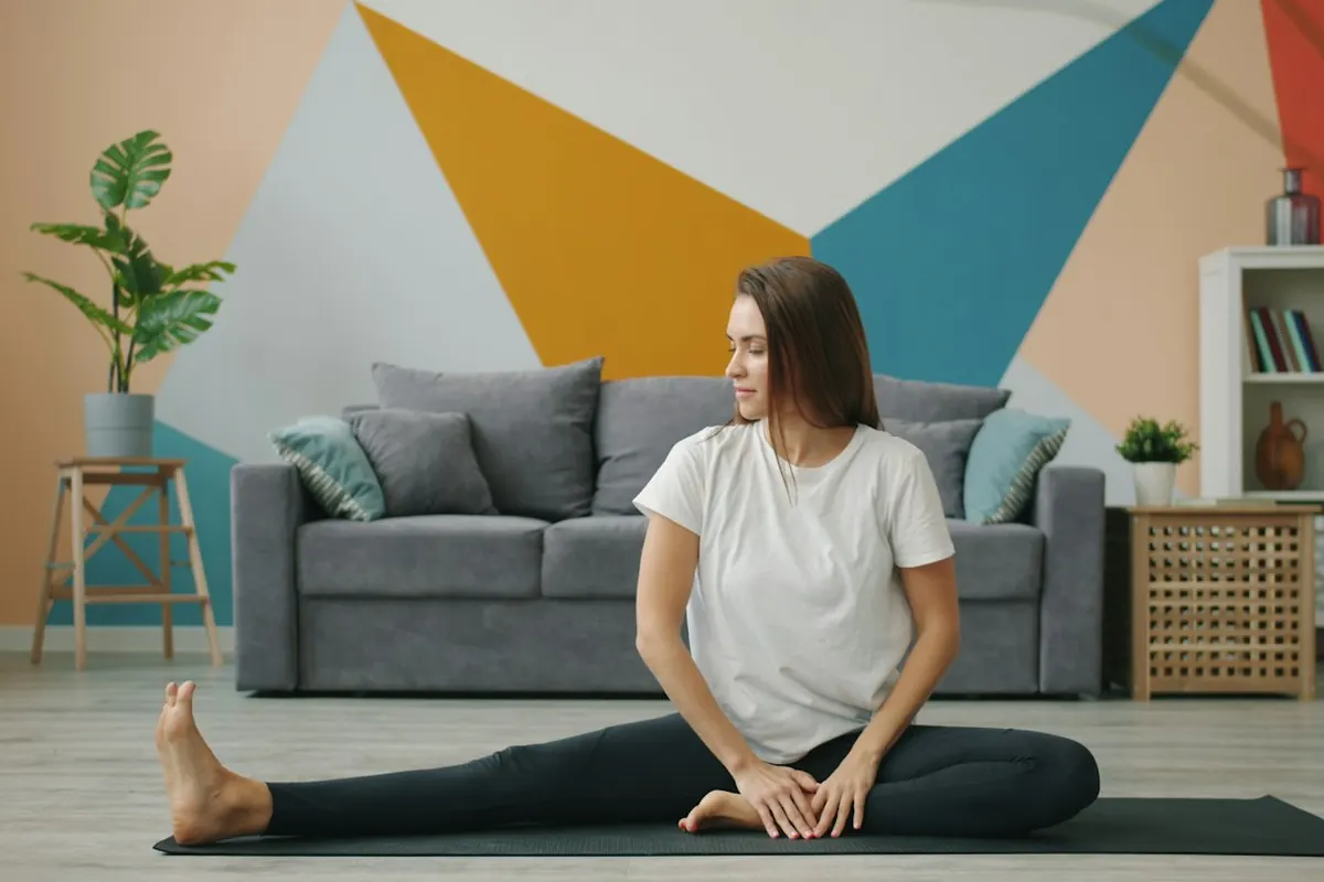 Woman stretching on a yoga mat in living room